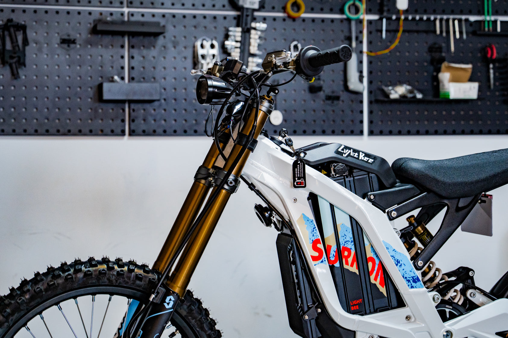 SURRON Light Bee X 2026 electric dirt bike in white, rear angle view